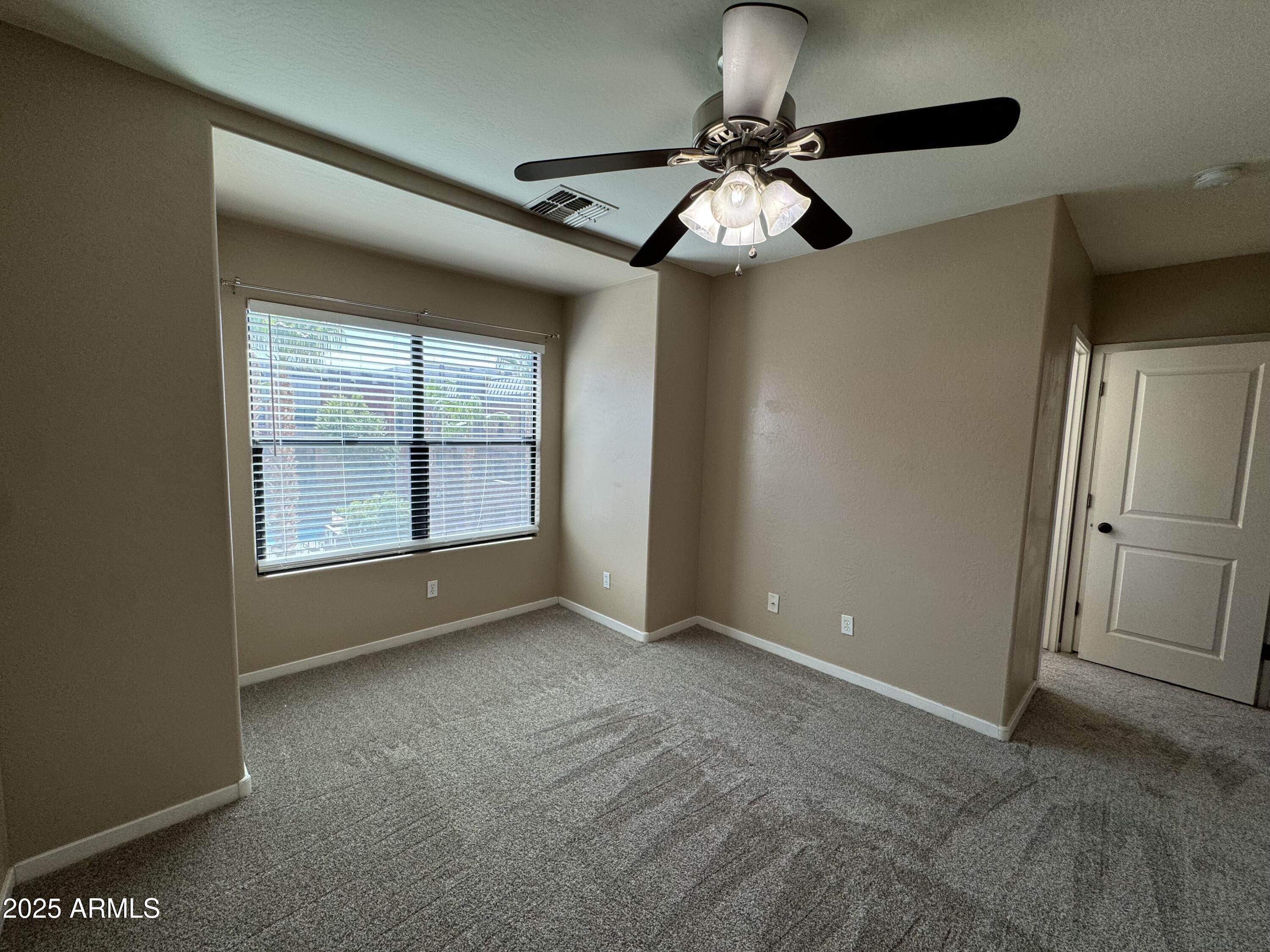 305 South Wilson Street, Unit 111 Tempe, AZ 85281 - Photo 26 of 48 a view of an empty room with a chandelier fan and a window