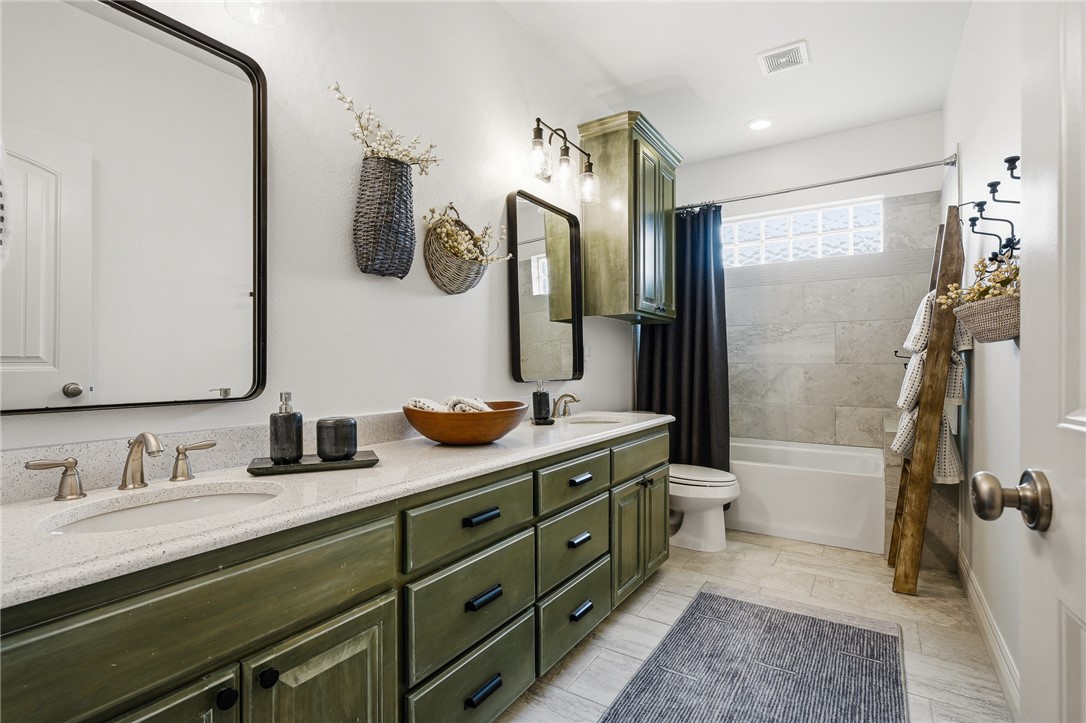 8710 KIng Ranch Drive Corpus Christi, TX 78414 - Photo 14 of 38 a bathroom with a double vanity sink mirror double and shower