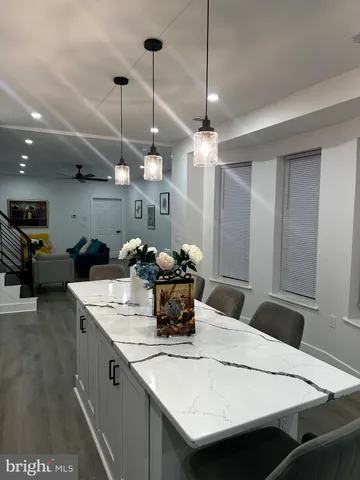 a large kitchen with a table and chairs