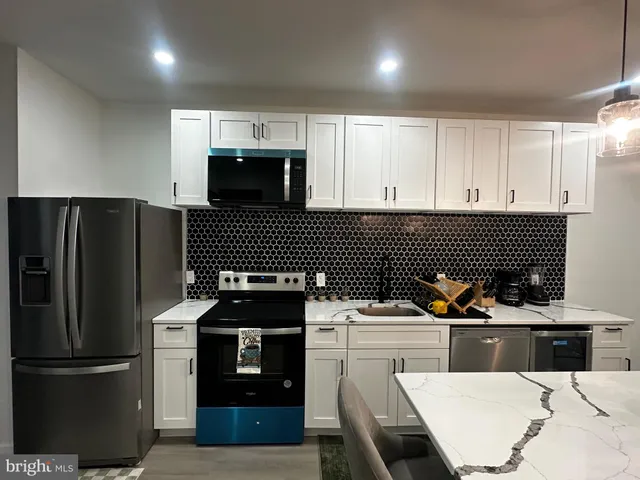 a kitchen with a sink a counter space and a dining table