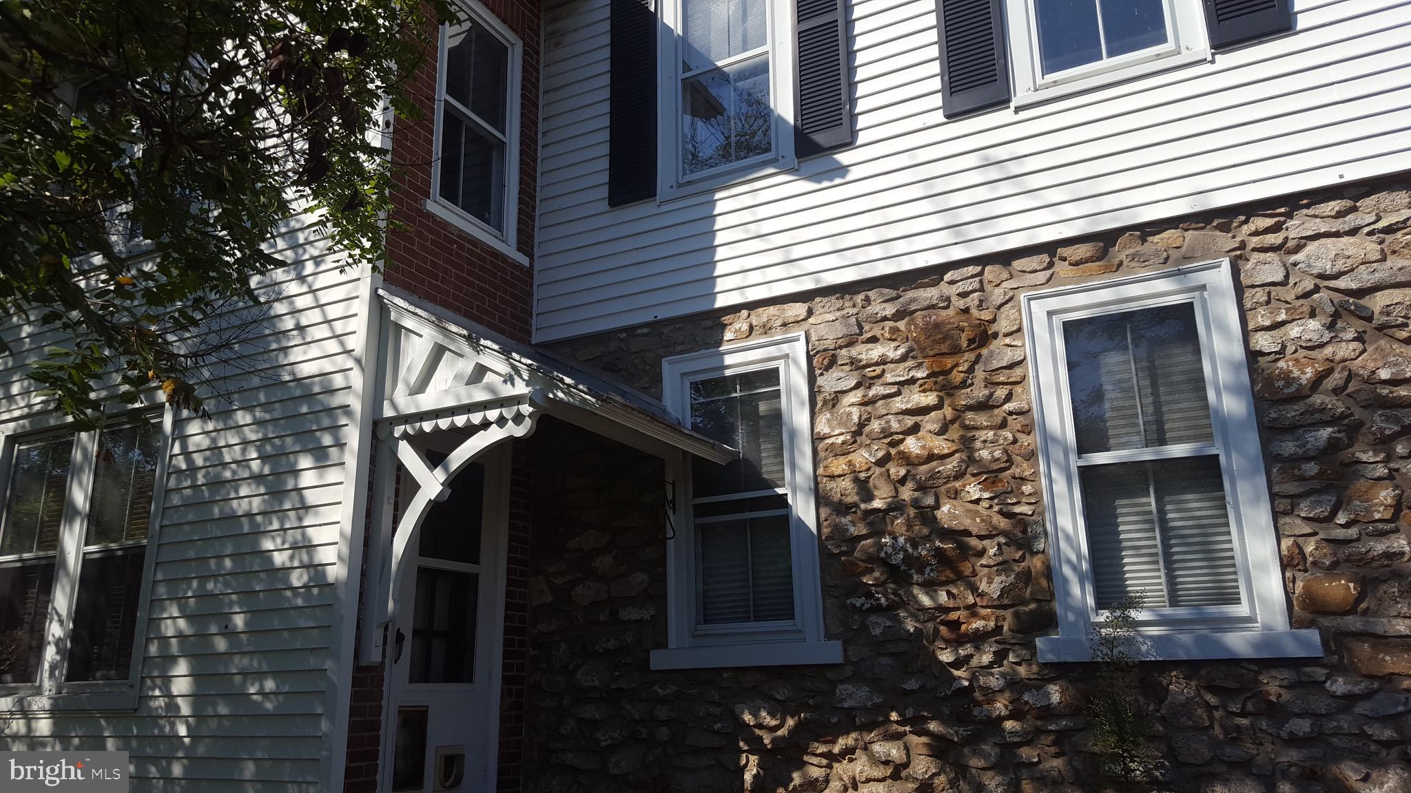 2902 Lower Saucon Road, Unit A&B Hellertown, PA 18055 - Photo 39 of 53 a view of a house with a door and a tree