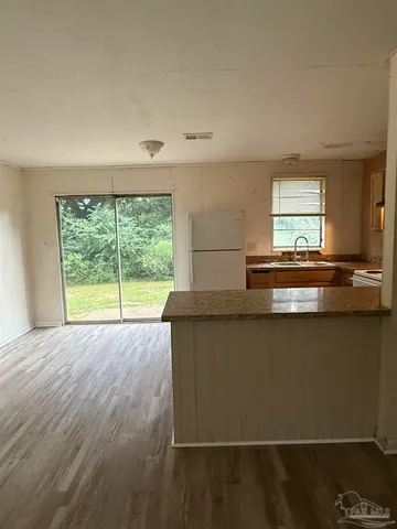 a kitchen with stainless steel appliances a large window and a sink