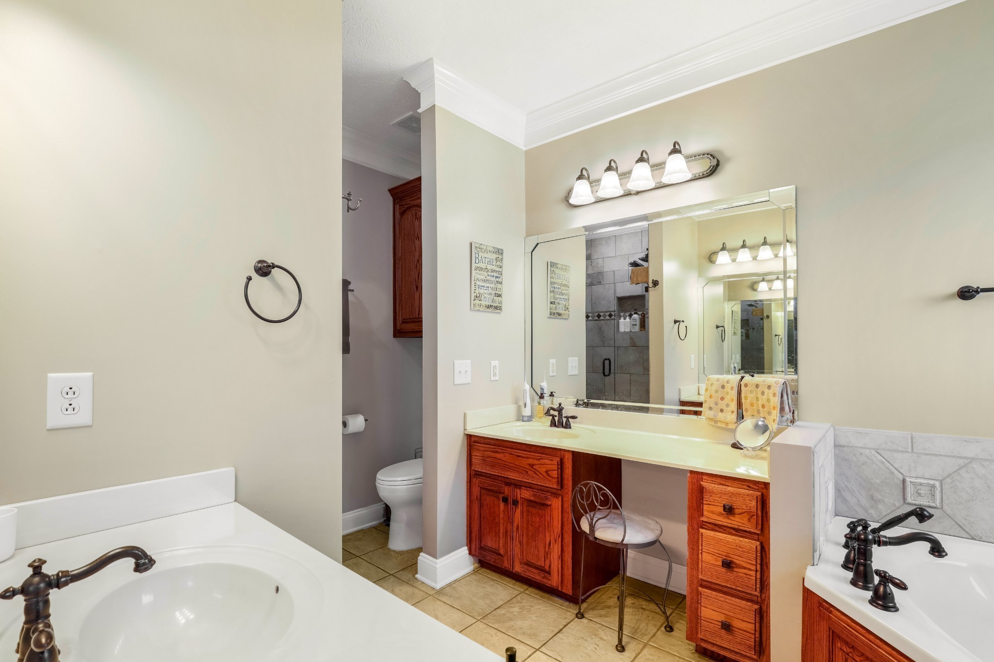 4984 Somerville Road Cross Plains, TN 37049 - Photo 46 of 57 a bathroom with a double vanity sink a toilet and a mirror