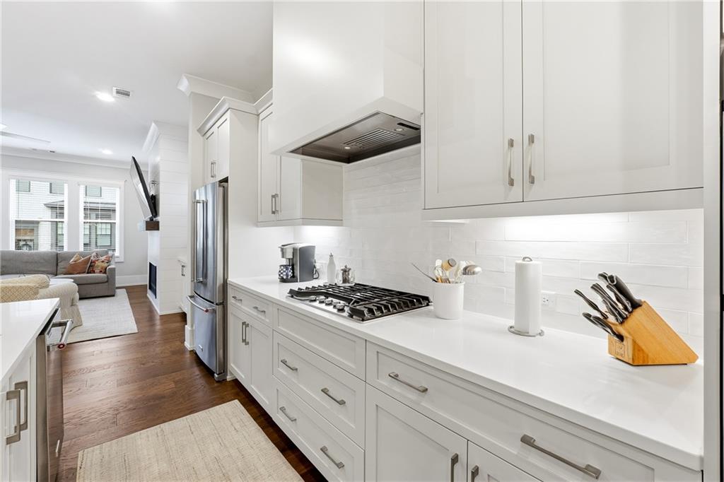 1307 Markham Road Atlanta, GA 30319 - Photo 12 of 47 a kitchen with stainless steel appliances granite countertop a stove and a white cabinets