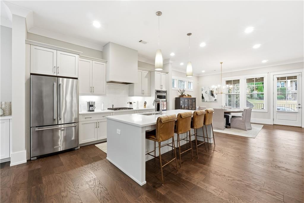 1307 Markham Road Atlanta, GA 30319 - Photo 14 of 47 a kitchen with stainless steel appliances kitchen island hardwood floor sink and stove