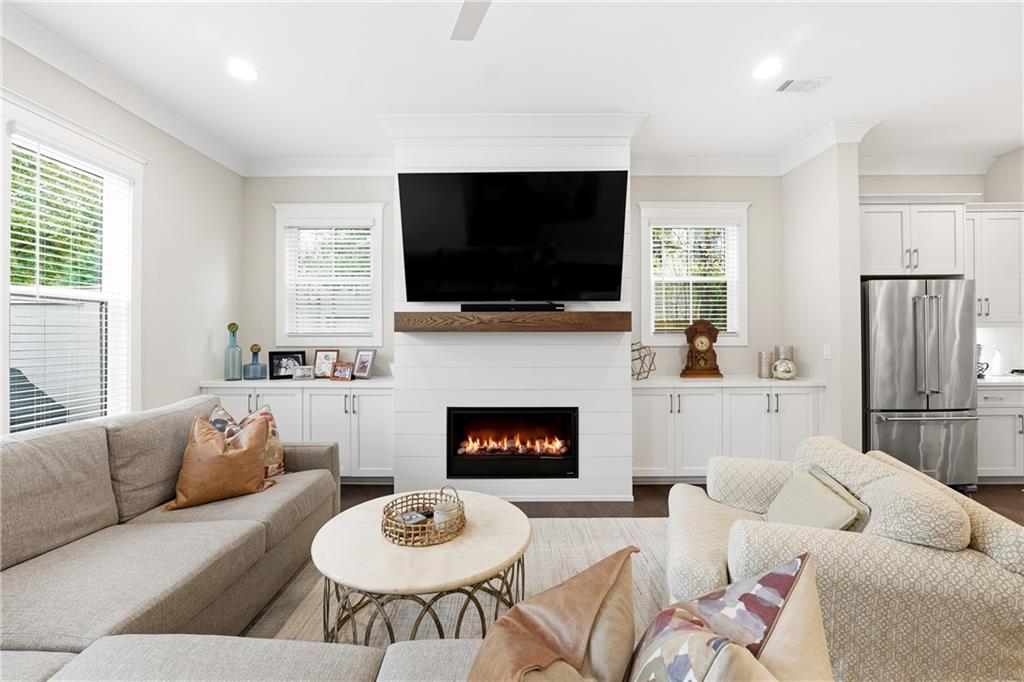 1307 Markham Road Atlanta, GA 30319 - Photo 17 of 47 a living room with furniture a flat screen tv and a fireplace