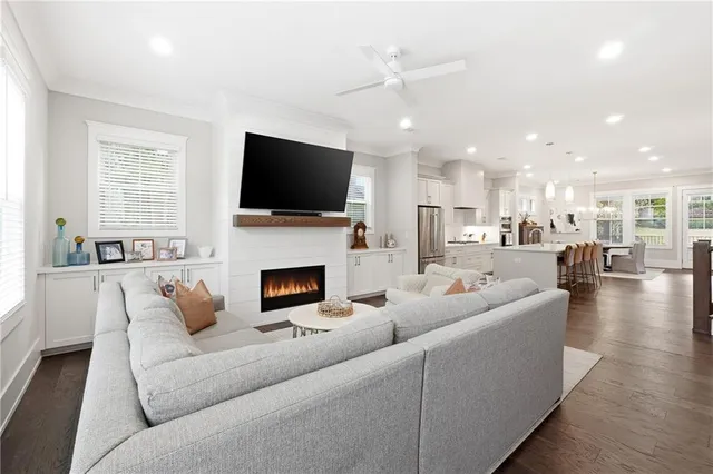 a living room with furniture a fireplace and a flat screen tv