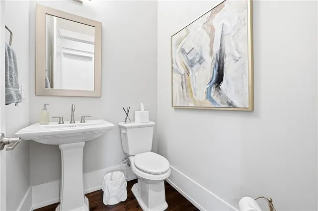 a bathroom with a toilet sink and mirror