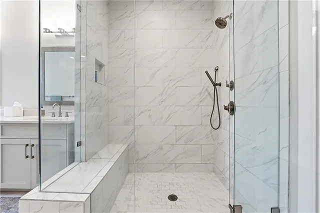 a bathroom with a shower and a sink