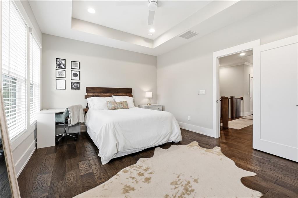 1307 Markham Road Atlanta, GA 30319 - Photo 30 of 47 a bedroom with a bed and wooden floor
