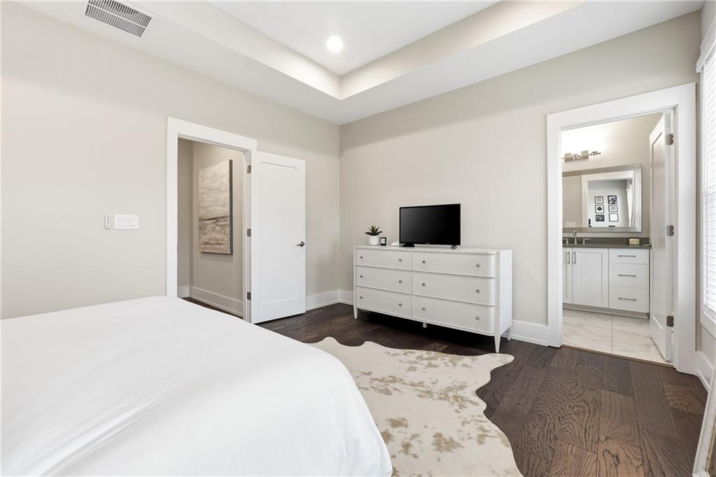 1307 Markham Road Atlanta, GA 30319 - Photo 31 of 47 a bedroom with a bed and flat screen tv