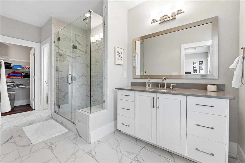 1307 Markham Road Atlanta, GA 30319 - Photo 32 of 47 a spacious bathroom with a shower sink and mirror