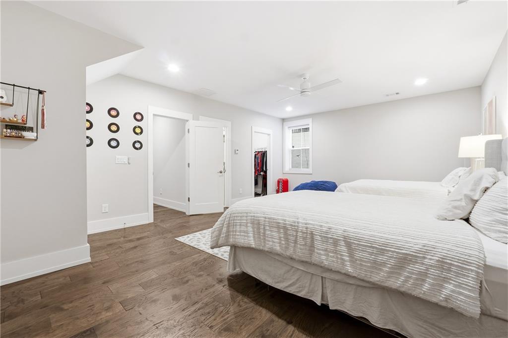 1307 Markham Road Atlanta, GA 30319 - Photo 34 of 47 a bedroom with a large bed and a chandelier