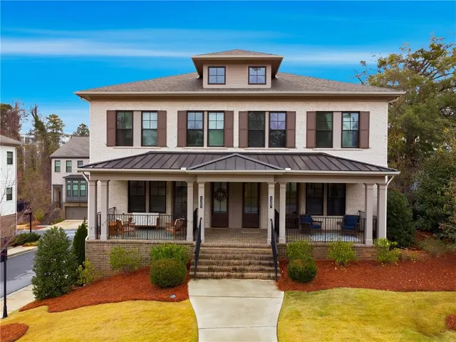 a front view of a house with garden and patio