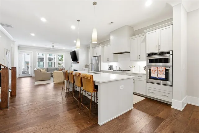 a kitchen with a refrigerator and a stove top oven