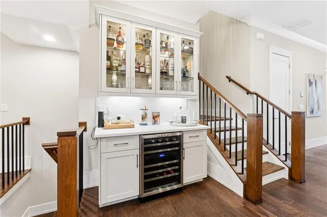 a view of a hallway with cabinet and wooden floor
