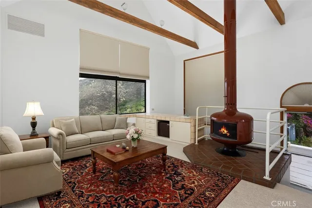 a living room with furniture a lamp and a table