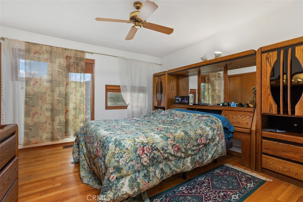 3264 Shearer Crossing Fallbrook, CA 92028 - Photo 20 of 41 a bedroom with a bed table and flat screen tv