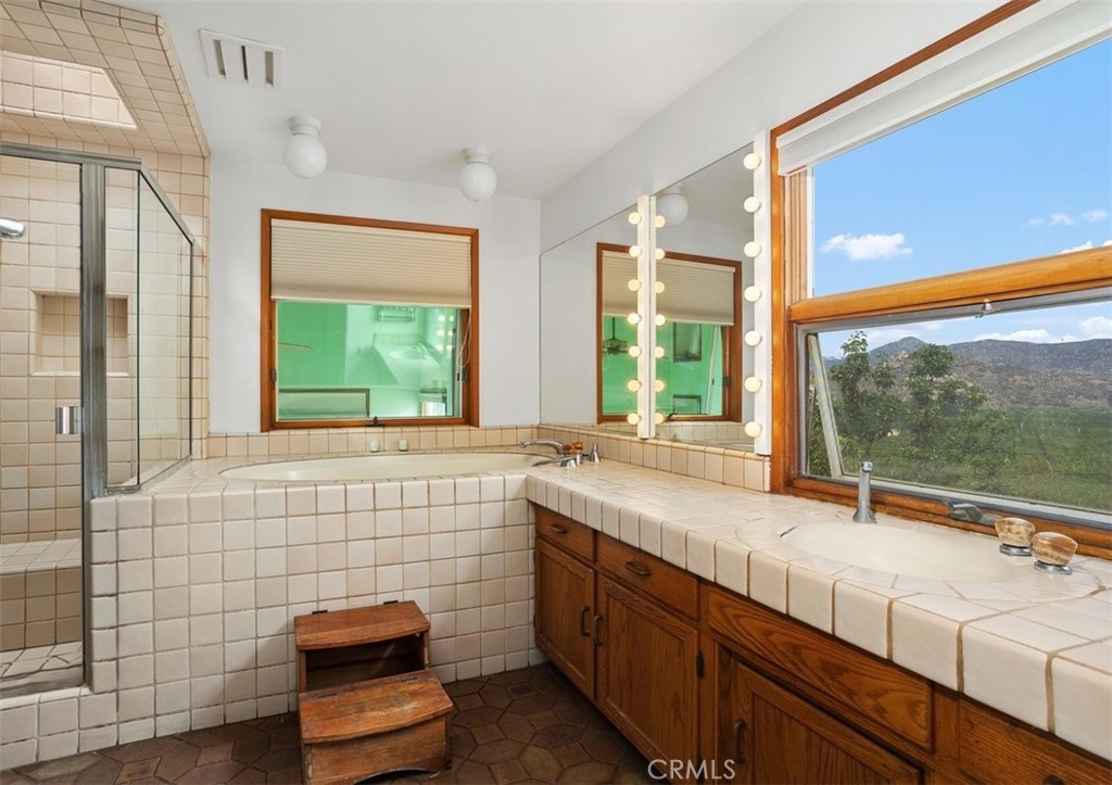 3264 Shearer Crossing Fallbrook, CA 92028 - Photo 23 of 41 a bathroom with a sink and a large mirror