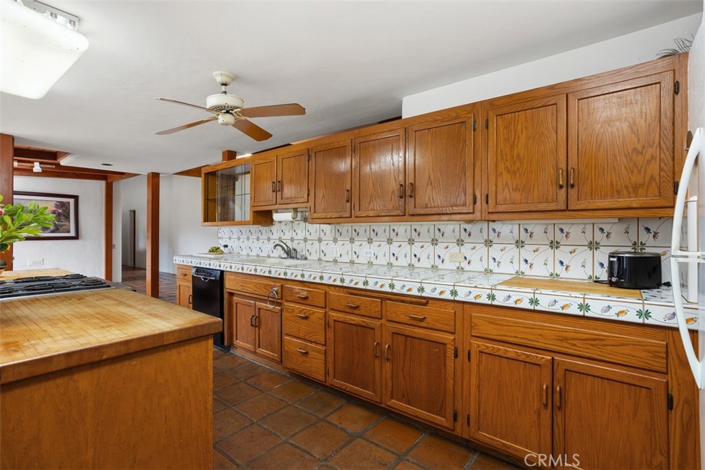 3264 Shearer Crossing Fallbrook, CA 92028 - Photo 9 of 41 a kitchen with granite countertop cabinets stainless steel appliances a sink and a counter top space