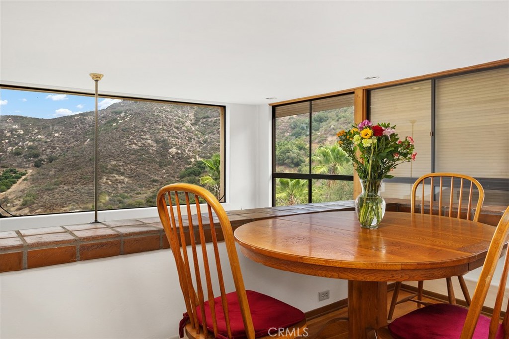 3264 Shearer Crossing Fallbrook, CA 92028 - Photo 10 of 41 a dining room with furniture a potted plant and wooden floor