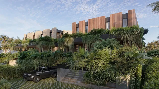 a view of a blue house with a yard and plants