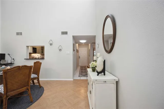 a dining room with furniture wooden floor and a chandelier