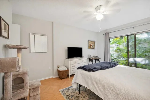 a bedroom with a large bed and a chandelier