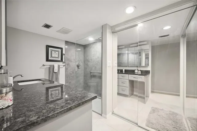 a kitchen with stainless steel appliances granite countertop a sink dishwasher and cabinets with wooden floor