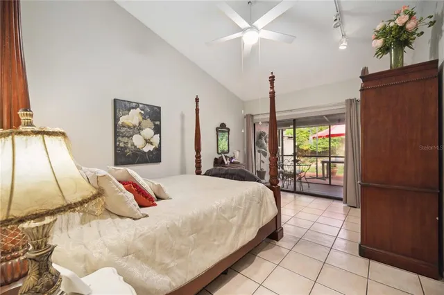 a bedroom with a bed and a mirror on dresser