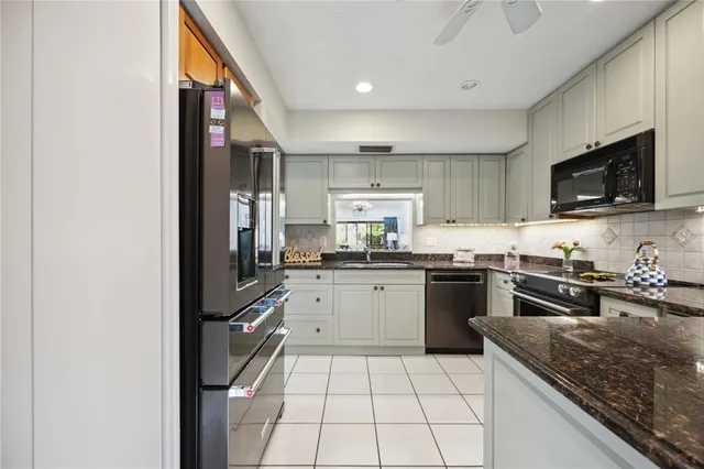 a kitchen with a sink stove and microwave