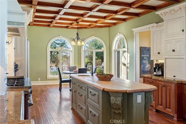 a view of a dining room with furniture large windows and wooden floor