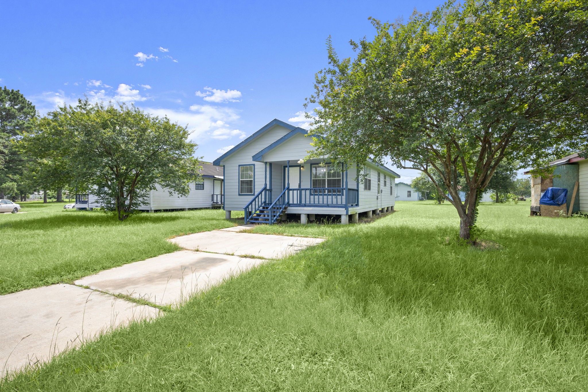 1935 1st Street Hempstead, TX 77445 - Photo 4 of 29 a view of a house with a big yard plants and large trees