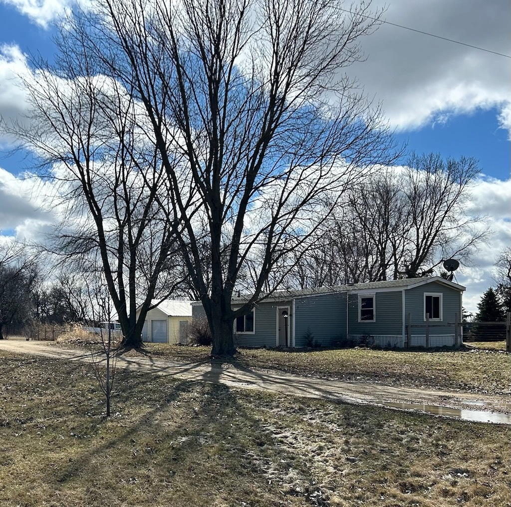 703 Maytown Road Ohio, IL 61349 - Photo 3 of 19 a front view of a house with a yard and trees