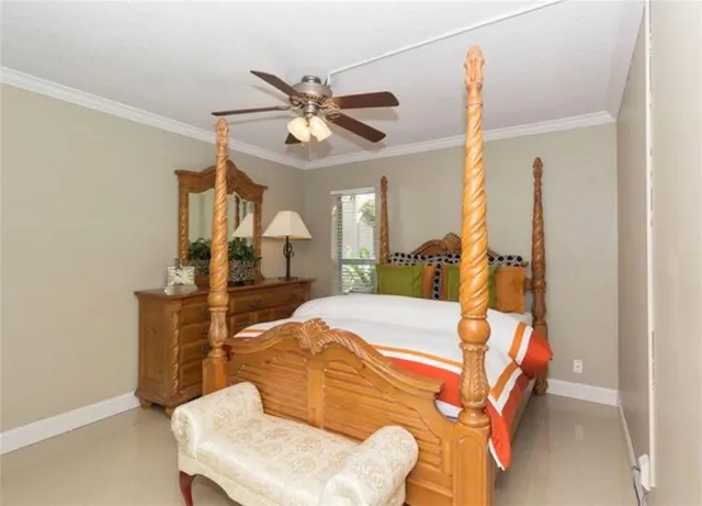 a bedroom with a bed and ceiling fan