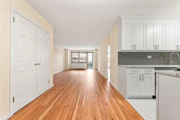 a view of a kitchen with wooden floor and electronic appliances