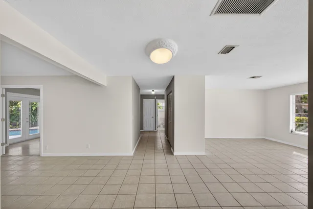 a view of empty room with wooden floor and window