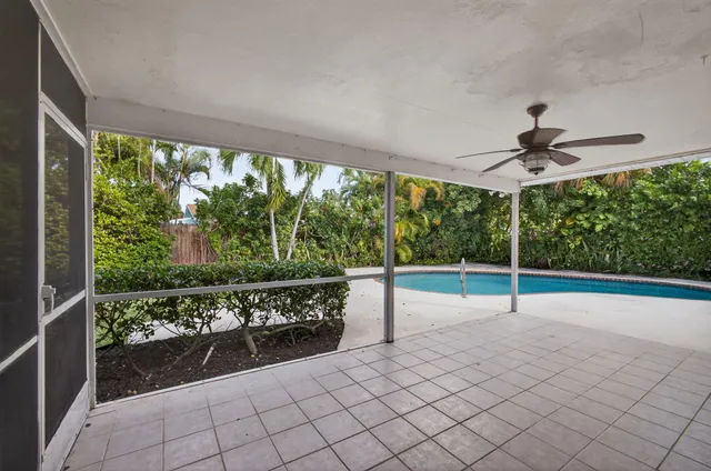 a view of a house with a yard and potted plants