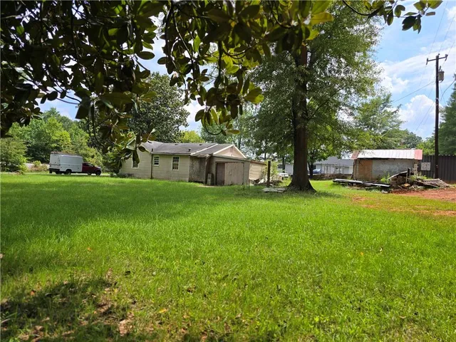 a house view with a sitting space and garden