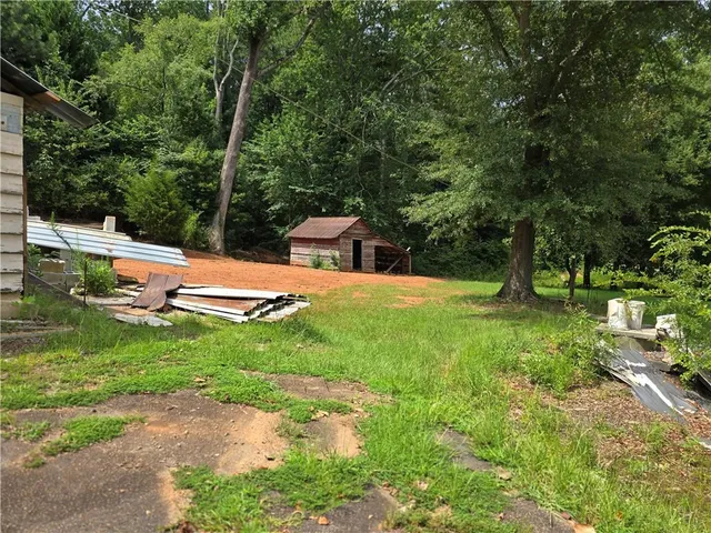 a view of backyard with swimming pool and patio