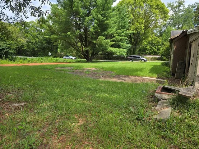 a view of a garden with lawn chairs