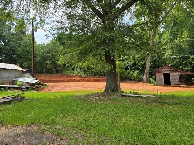 a view of backyard with swimming pool and patio