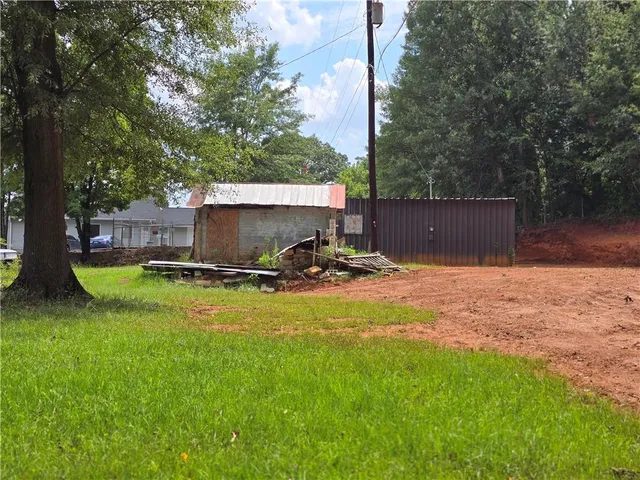 a view of a backyard with plants and a patio
