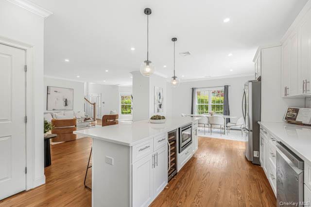 1 Kewanee Road New Rochelle, NY 10804 - Photo 12 of 36 a large kitchen with stainless steel appliances a lot of counter space and a wooden floor