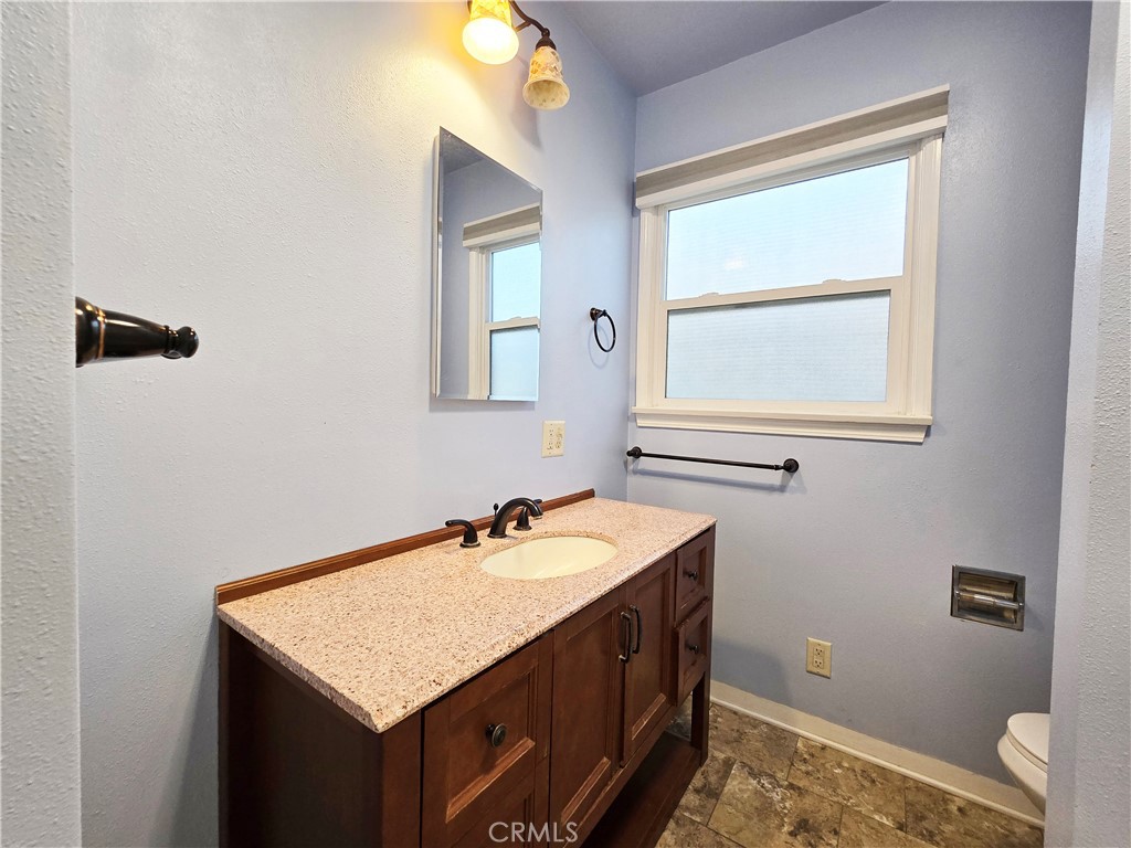3869 Bandini Avenue Riverside, CA 92506 - Photo 11 of 17 a bathroom with a sink a vanity and a window