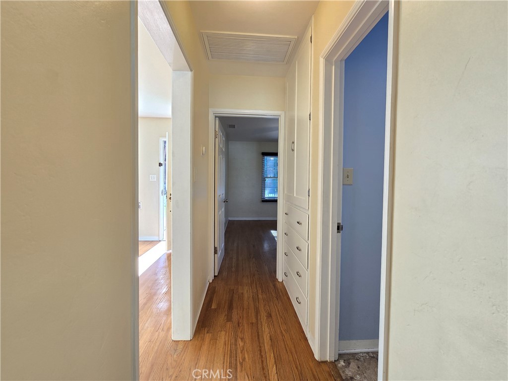 3869 Bandini Avenue Riverside, CA 92506 - Photo 13 of 17 a view of a hallway with wooden floor