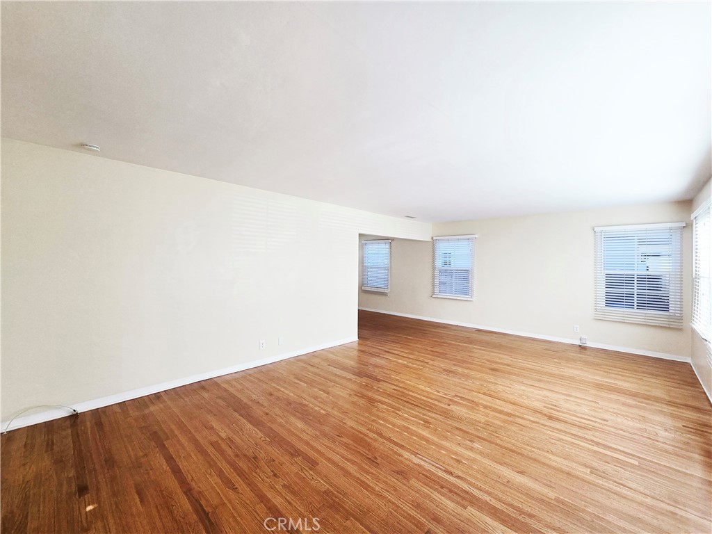 3869 Bandini Avenue Riverside, CA 92506 - Photo 2 of 17 a view of an empty room with wooden floor and a window