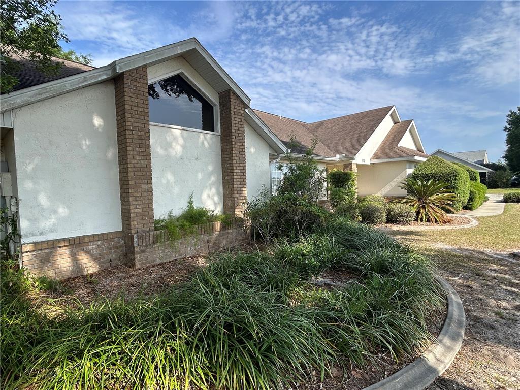 9528 Southeast 70th Terrace Ocala, FL 34472 - Photo 1 of 43 a view of a small house with a yard and plants