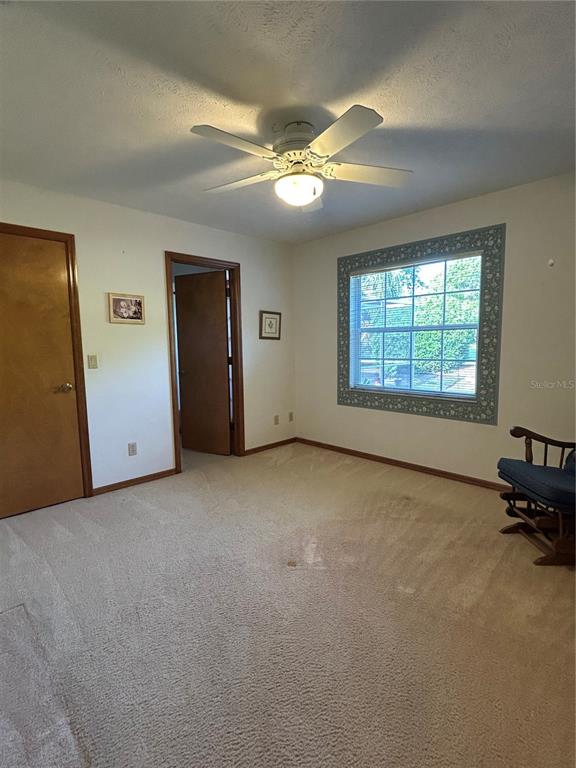 9528 Southeast 70th Terrace Ocala, FL 34472 - Photo 16 of 43 an empty room with a fireplace and windows