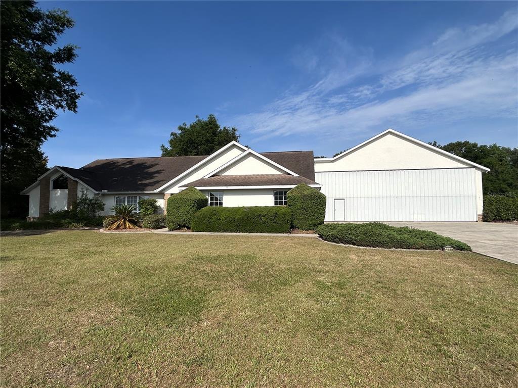 9528 Southeast 70th Terrace Ocala, FL 34472 - Photo 2 of 43 a house with yard and a outdoor space